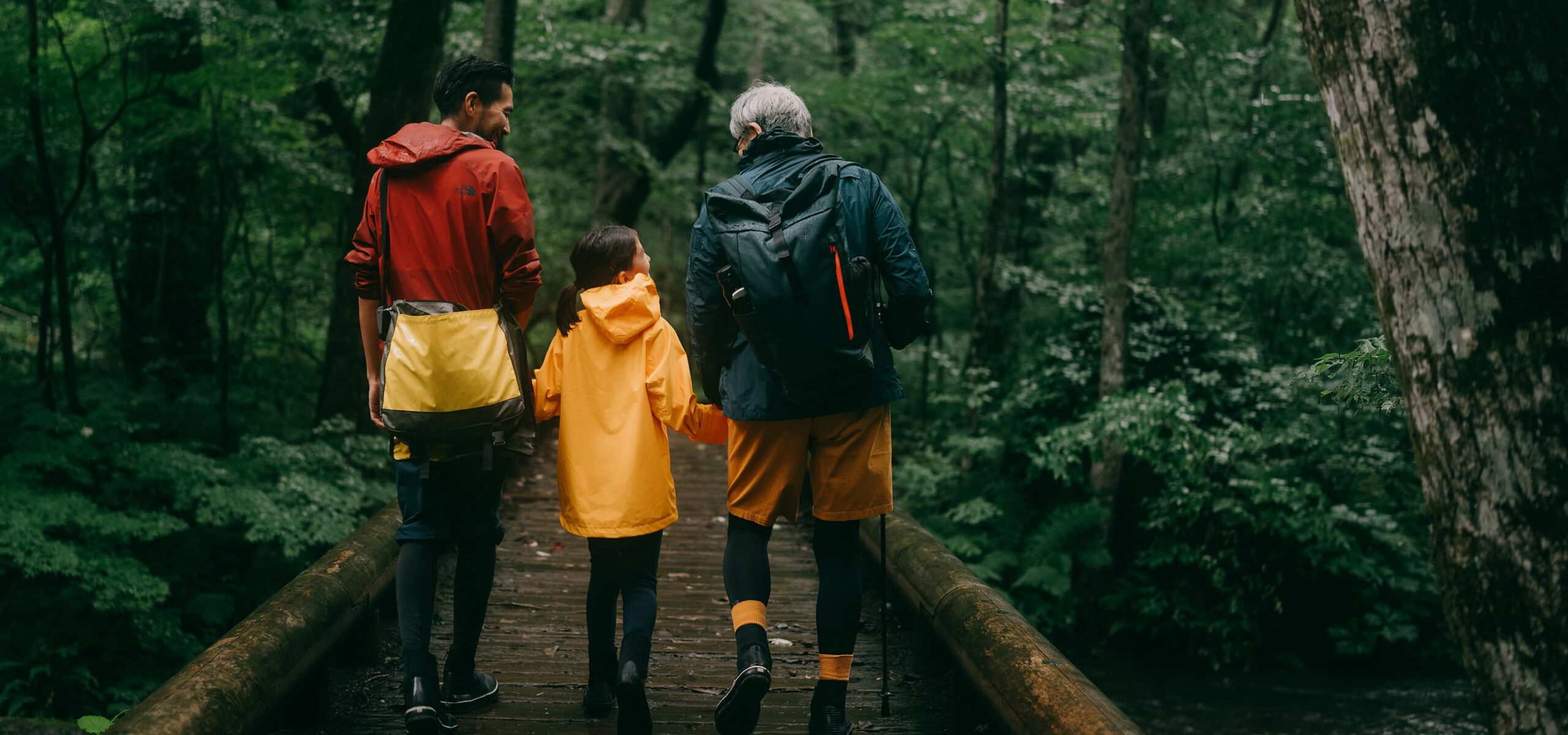 Family hiking in raincoats