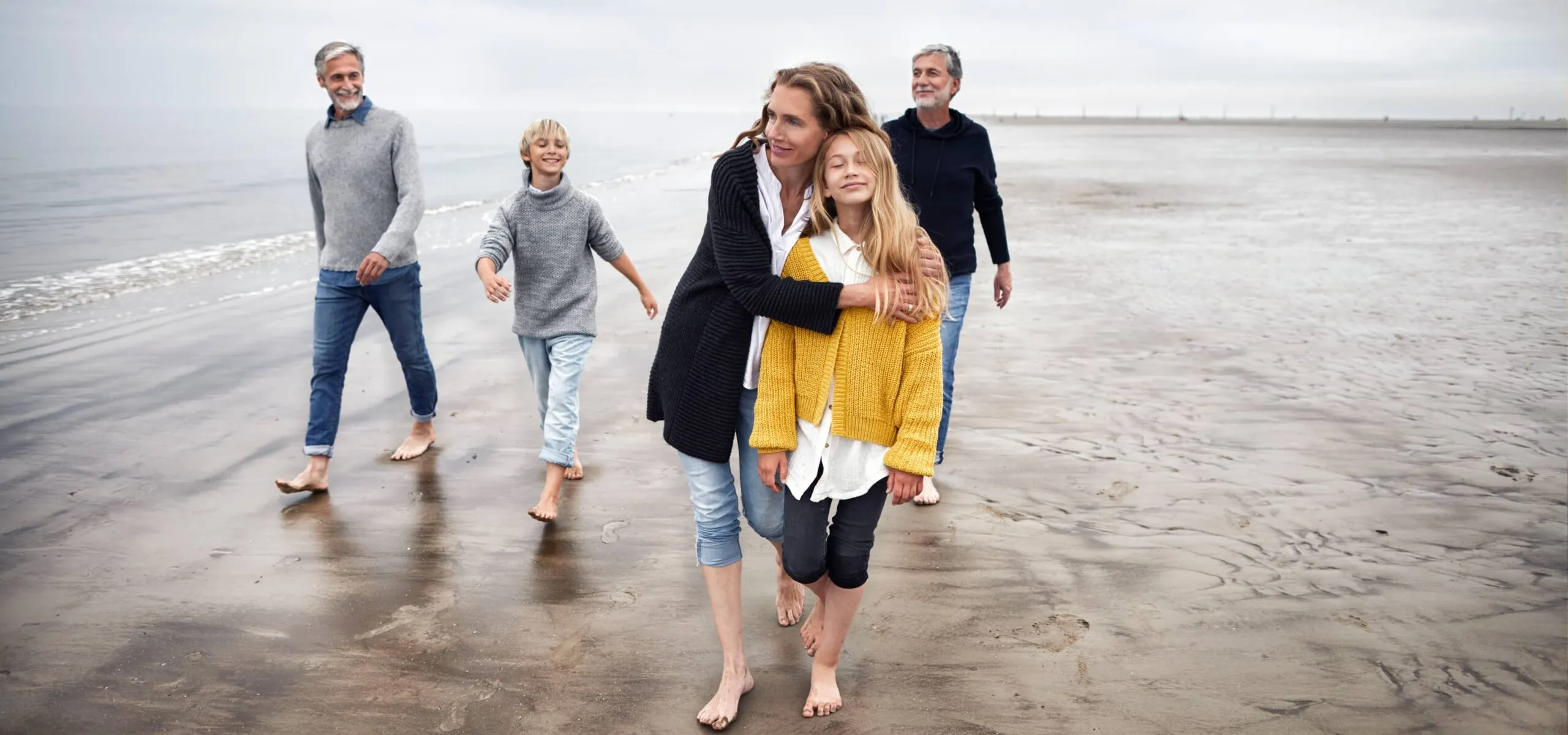 Family enjoying a walk on the beach