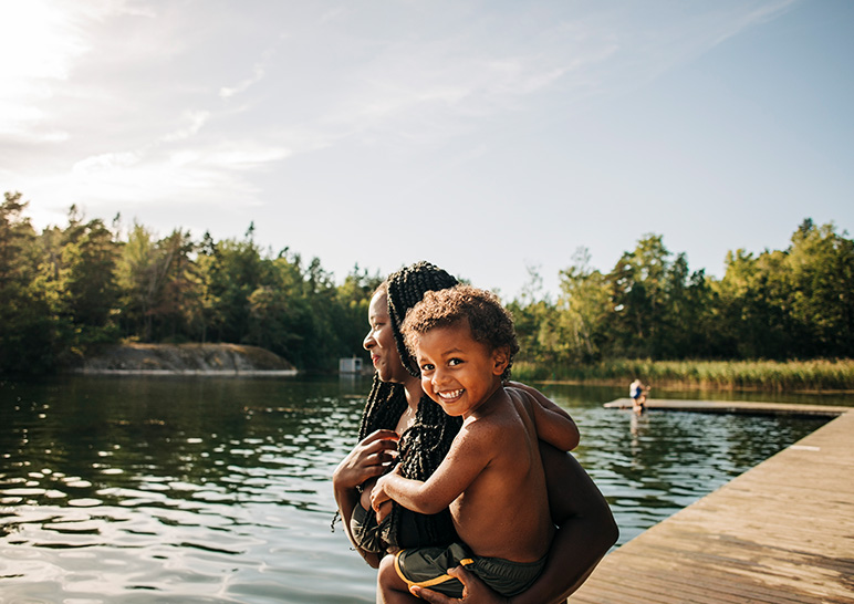 Mother and son swimming in a lake